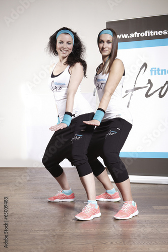 Two fitness girls exercising new sport