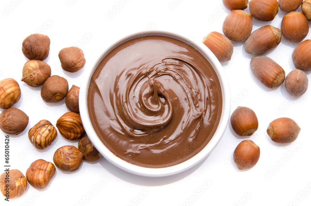 A cup of chocolate hazelnut spread with hazelnuts A cup of chocolate hazelnut spread with hazelnuts