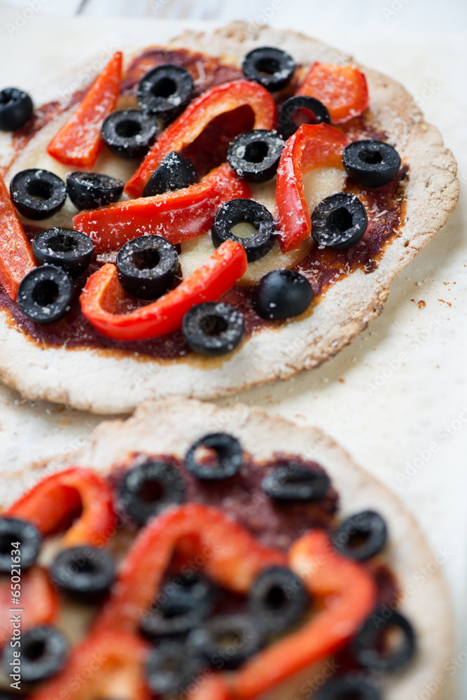 Close-up of mini pizzas with red bell pepper and olives Close-up of mini pizzas with red bell pepper and olives