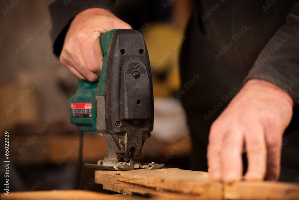 Elderly carpenter working in his workshop