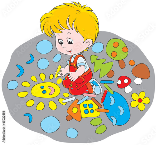 Little boy drawing with chalk a funny picture