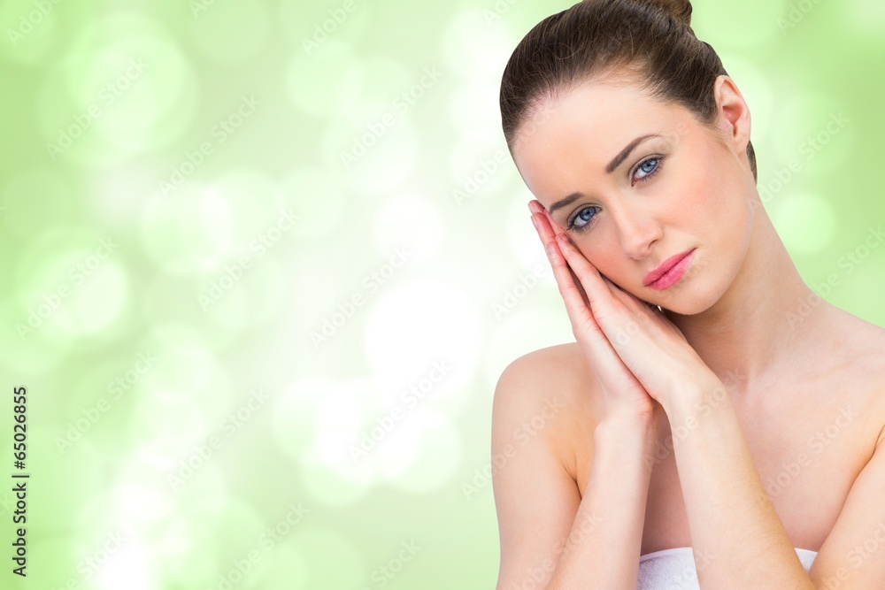 Composite image of beautiful brunette with hands at face Composite image of beautiful brunette with hands at face