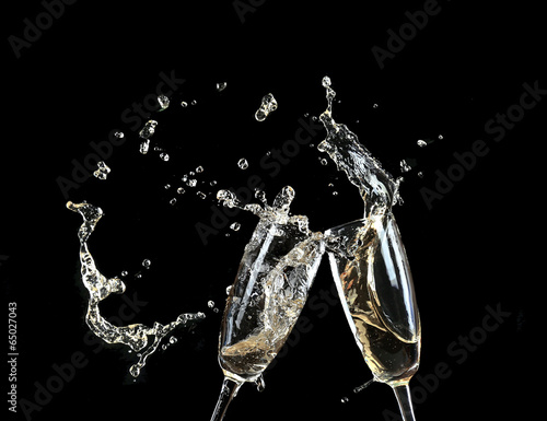 Vászonkép Glasses of champagne with splash, on black background