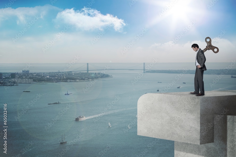 Composite image of wound up businessman with hands on hips