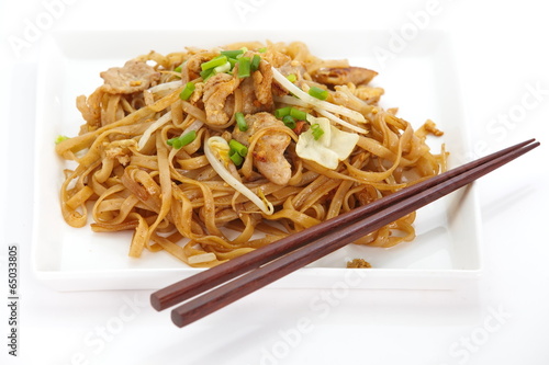 asian food fried rice noodles with pork and vegetables