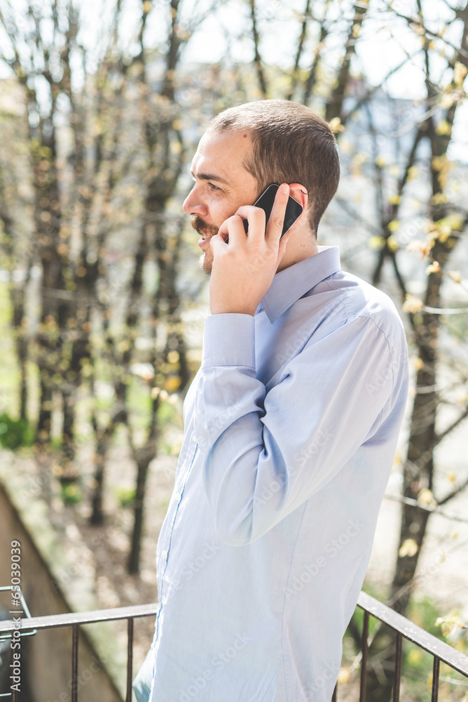 elegant business multitasking multimedia man calling with smartp elegant business multitasking multimedia man calling with smartp