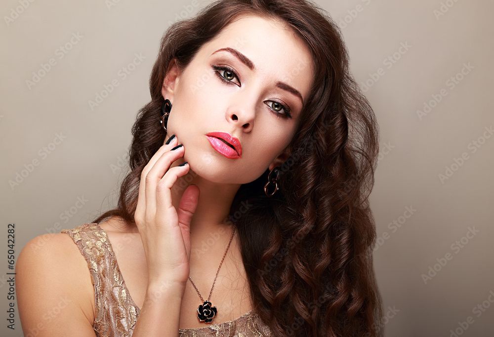 Beautiful bright makeup woman with long hair touching the face