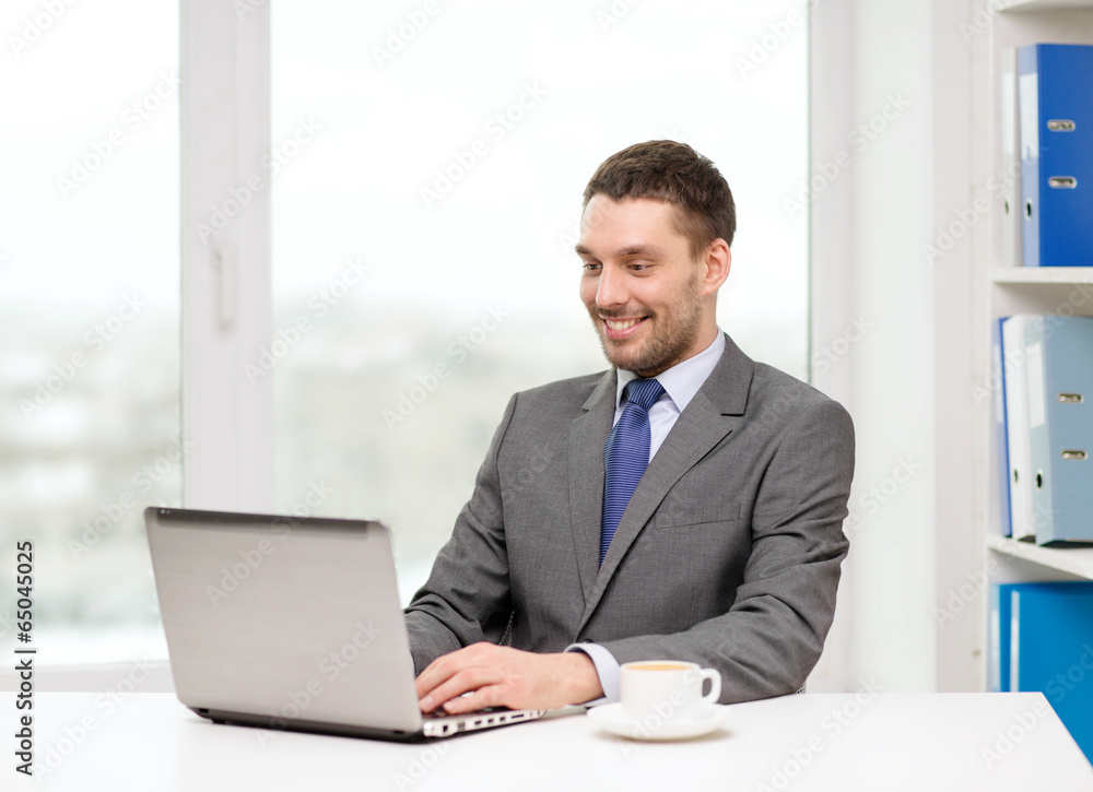 smiling businessman with laptop and coffee smiling businessman with laptop and coffee