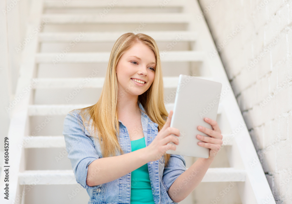 smiling female student with tablet pc computer - obrazy, fototapety, plakaty 