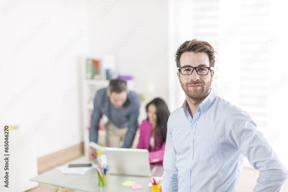 businessman standing in front of his colleagues in office