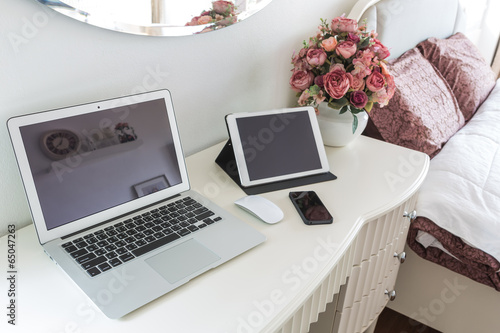 laptop with tablet and smart phone on table