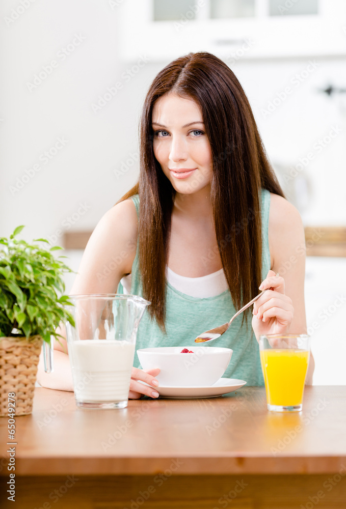 Portrait of the girl eating healthy muesli with milk Portrait of the girl eating healthy muesli with milk