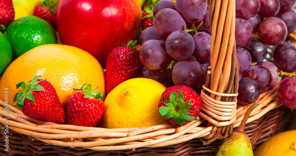 Variety of fresh fruits in wicker basket Variety of fresh fruits in wicker basket