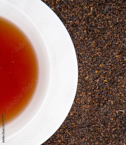 A cup of tea on dried and processed tea leaves