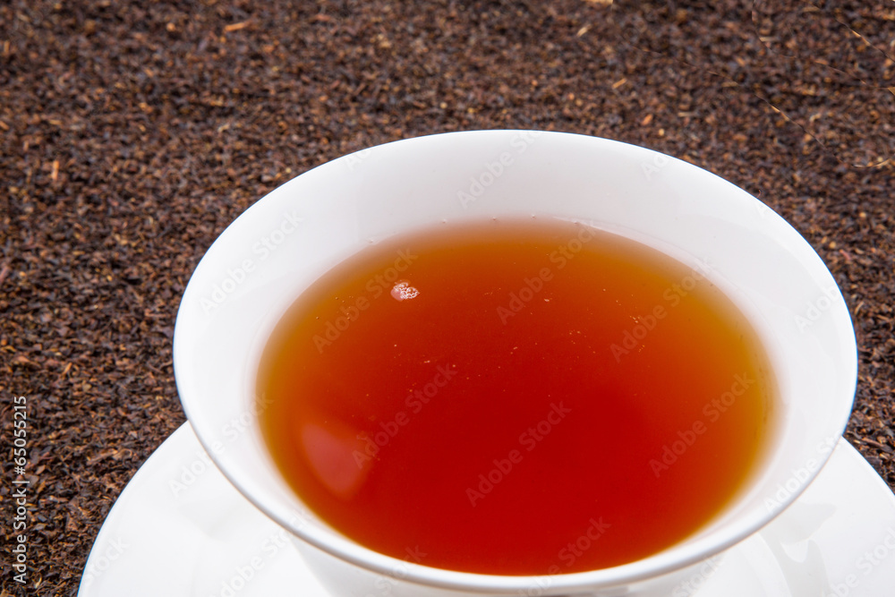 A cup of tea on dried and processed tea leaves A cup of tea on dried and processed tea leaves