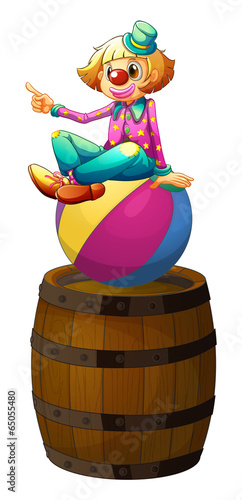 A ball with a clown above the wooden barrel