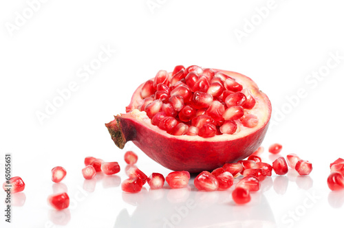 Pomegranate with seeds over white
