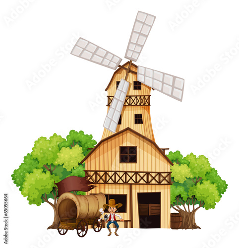 A wagon with an armed gunman standing infront of the wooden hous
