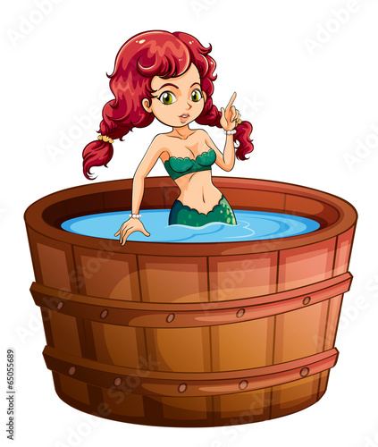 A mermaid inside the big wooden bathtub