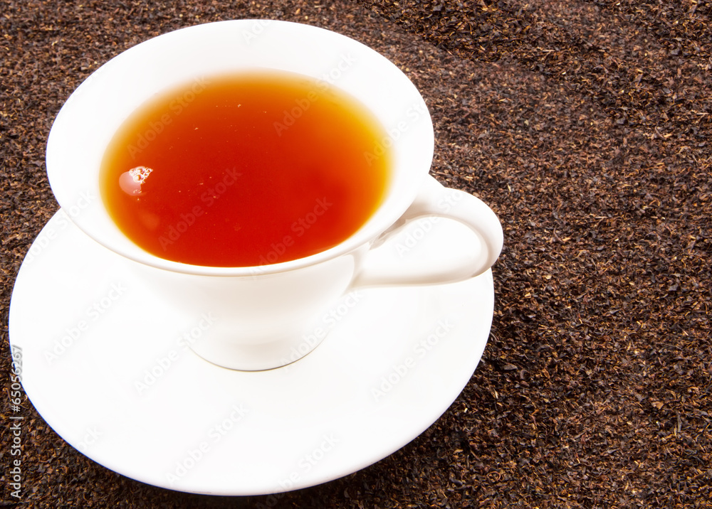 A cup of tea on dried and processed tea leaves A cup of tea on dried and processed tea leaves