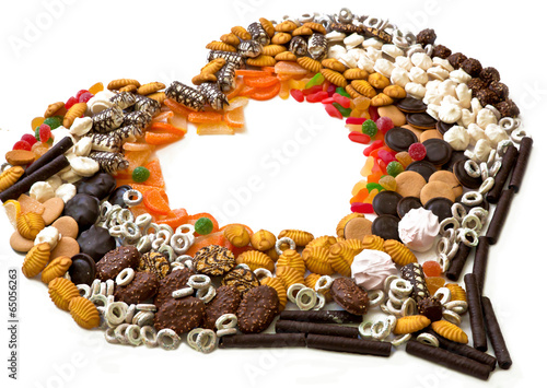 Печенье, конфеты, безе  на белом фоне в виде сердца photo