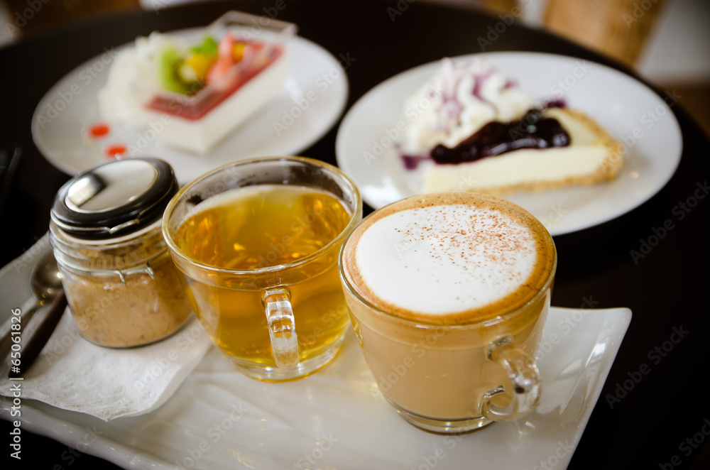 hot cappuccino and hot tea with cakes. hot cappuccino and hot tea with cakes.