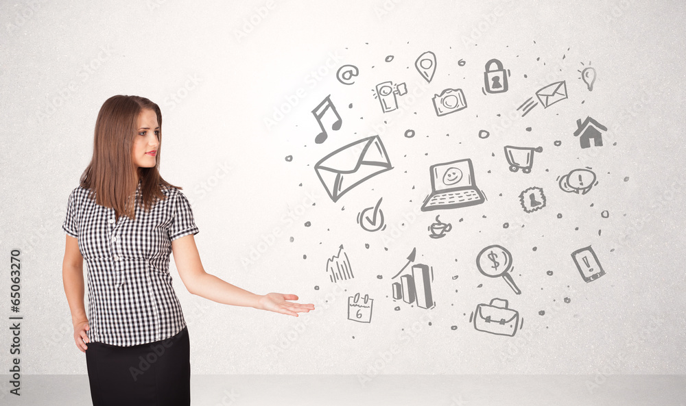 Young business woman presenting hand drawn media icons Young business woman presenting hand drawn media icons