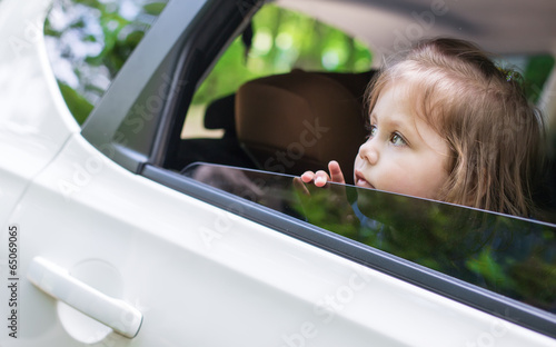 Cute  little child looks out the window