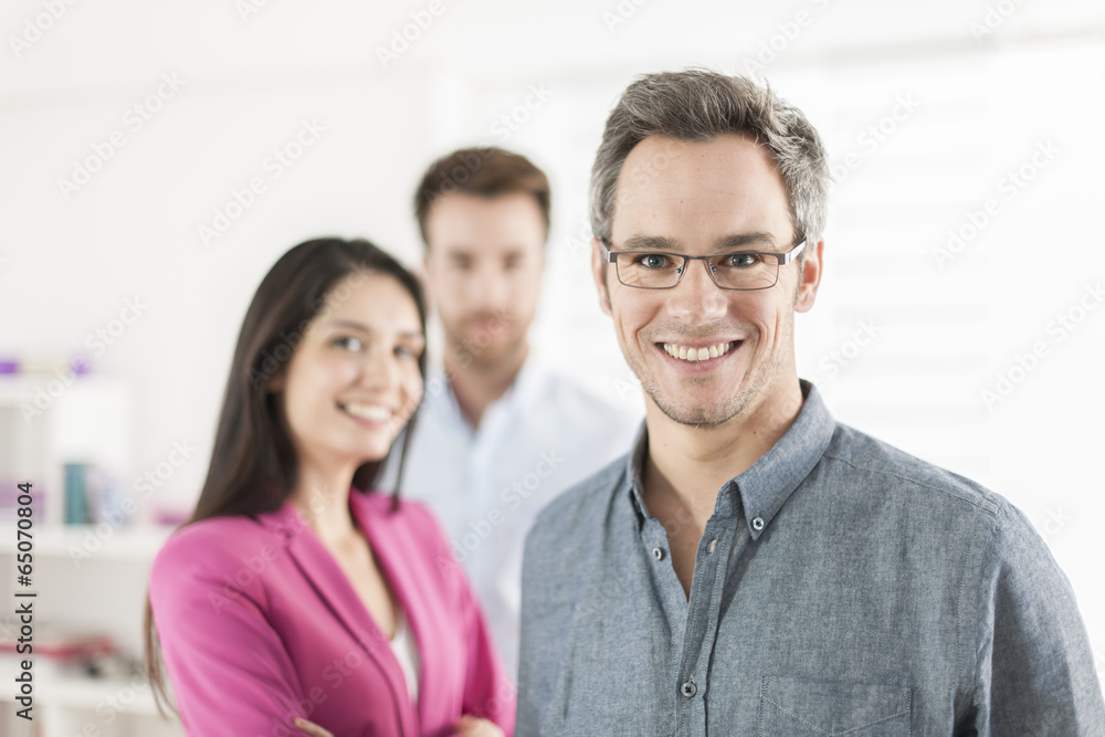 Portrait of a smiling senior businessman in the foreground Portrait of a smiling senior businessman in the foreground