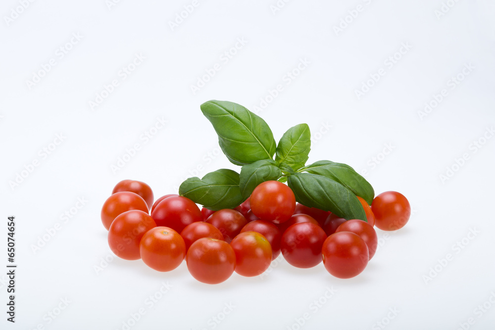 fresh cherry tomatoes with basil, on white background fresh cherry tomatoes with basil, on white background