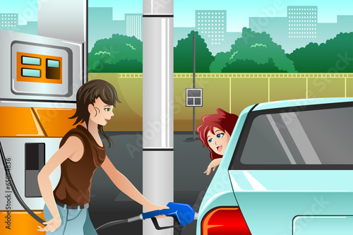 People filling up gasoline at the gas station