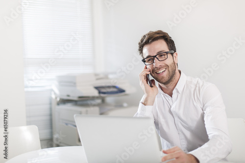 handsome businessman at office in front his laptop