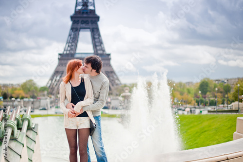 Loving couple kissing near the Eiffel Tower in Paris © nataliaderiabina