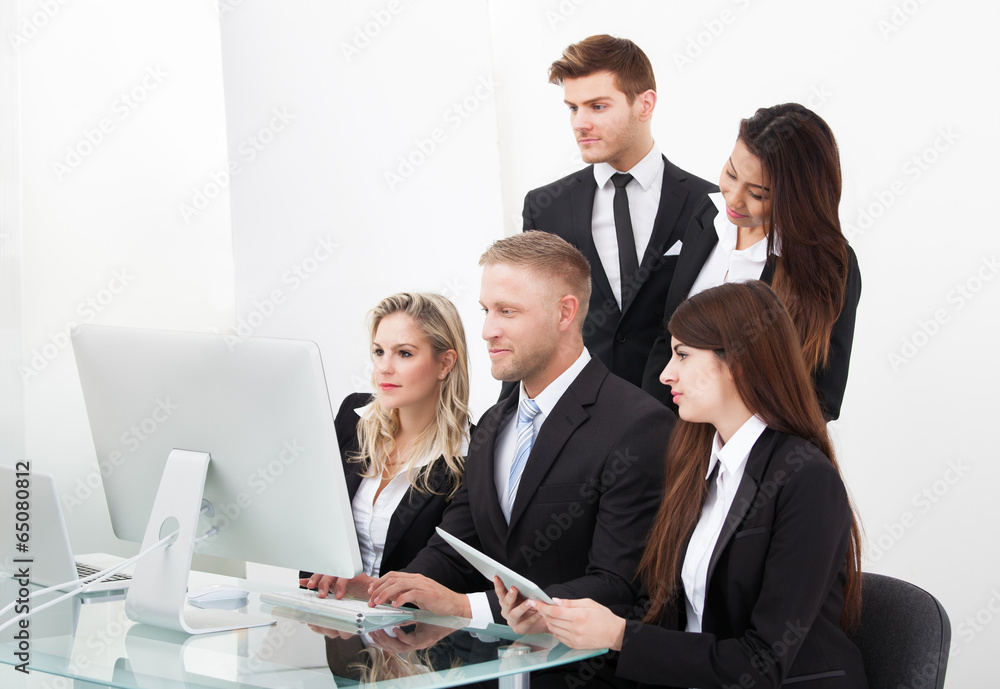 Businesspeople Using Desktop PC Businesspeople Using Desktop PC