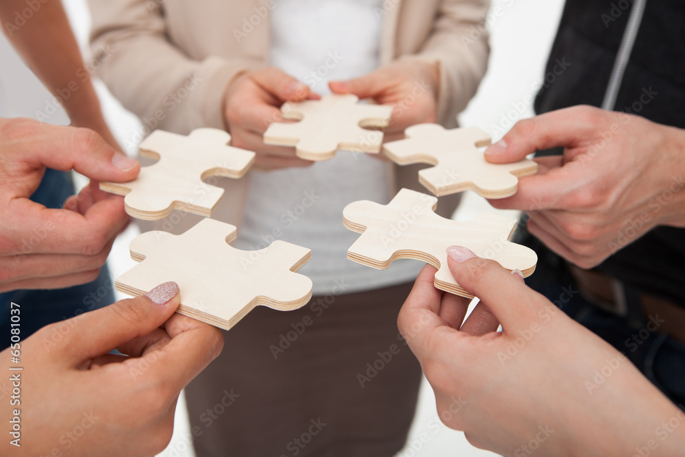 Businesspeople Joining Puzzle Pieces Businesspeople Joining Puzzle Pieces