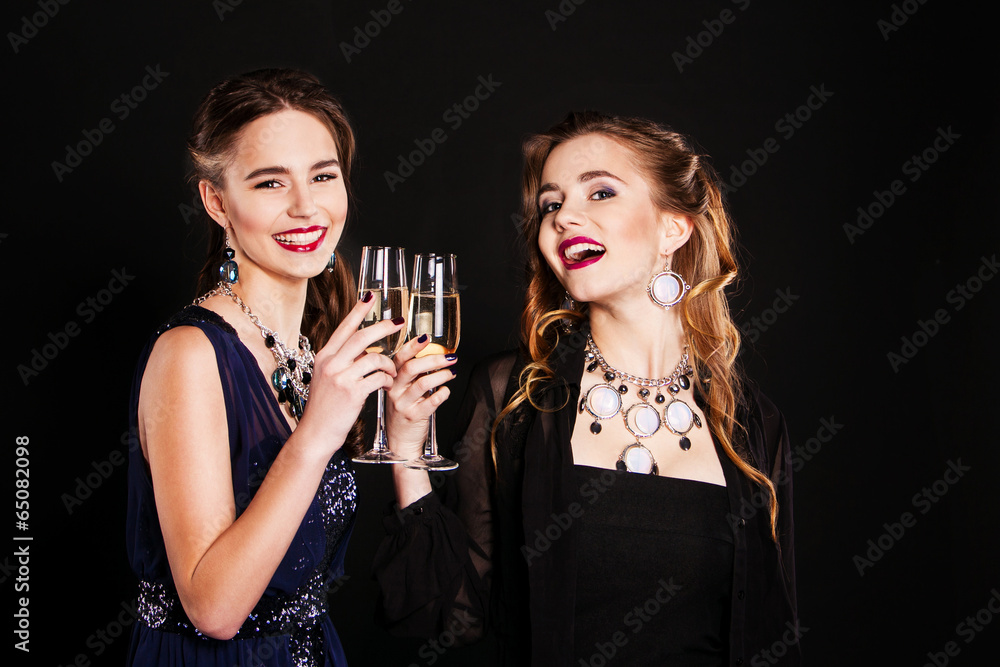 two stylish young women with glasses of champagne