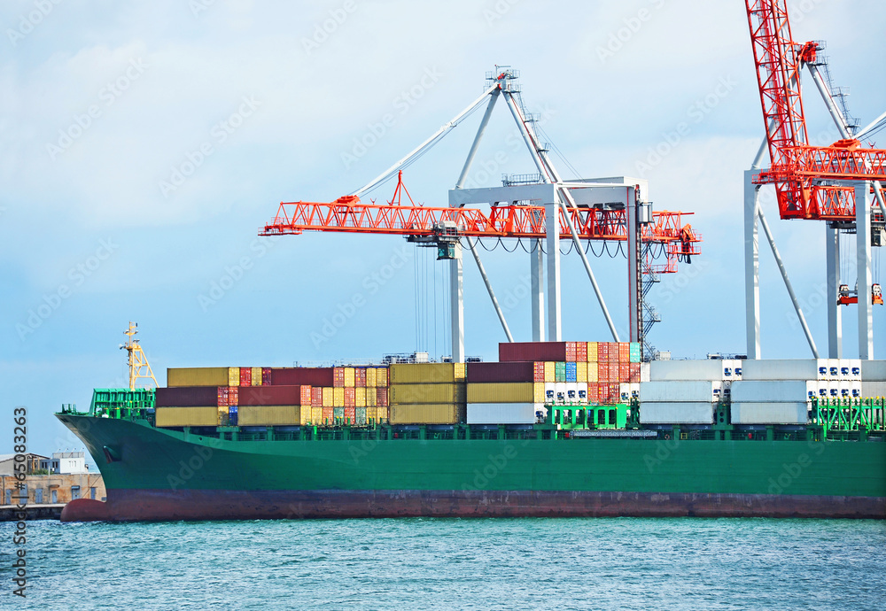 Fototapeta premium Container stack and ship under crane bridge