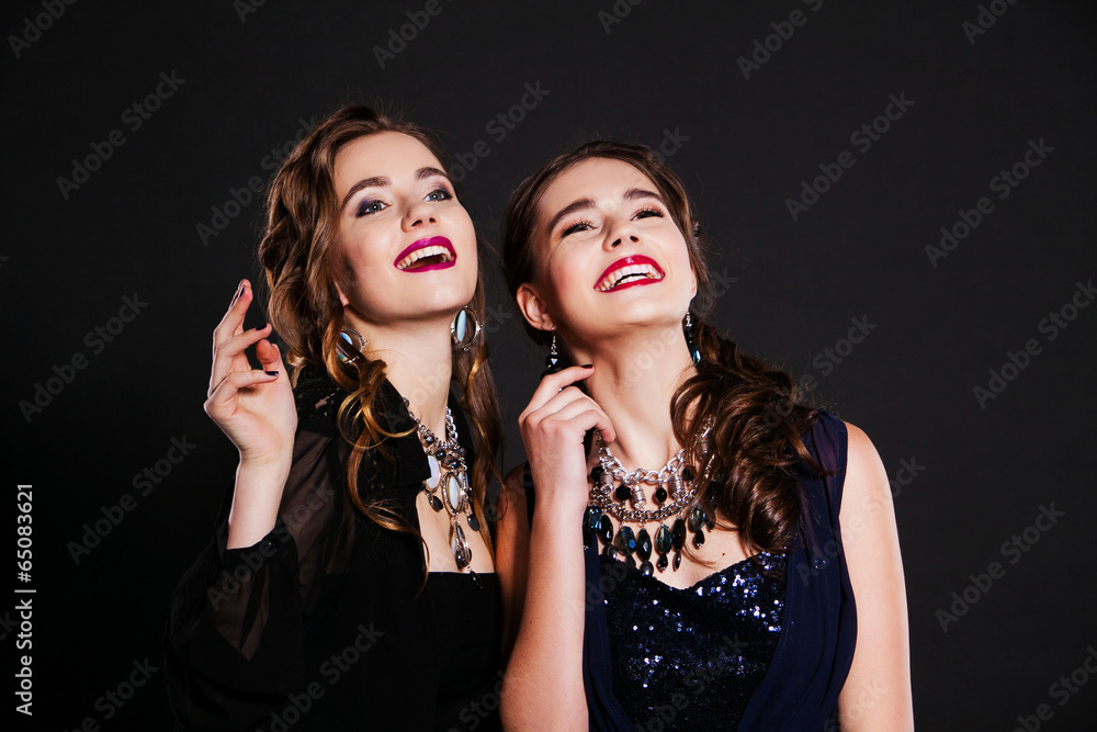 two smiling girls in evening dresses two smiling girls in evening dresses