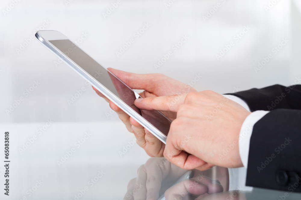 Businessman Holding Digital Tablet At Desk Businessman Holding Digital Tablet At Desk