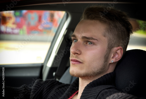Attractive young blond man sitting in his car © theartofphoto