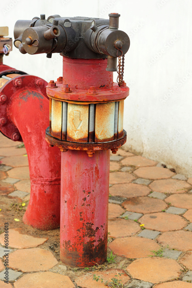 red rusty metal industrial water pipes with a valve. red rusty metal industrial water pipes with a valve.