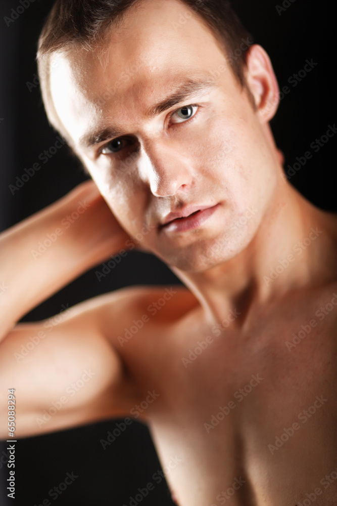 Portrait of a naked muscular man, isolated on black background Portrait of a naked muscular man, isolated on black background