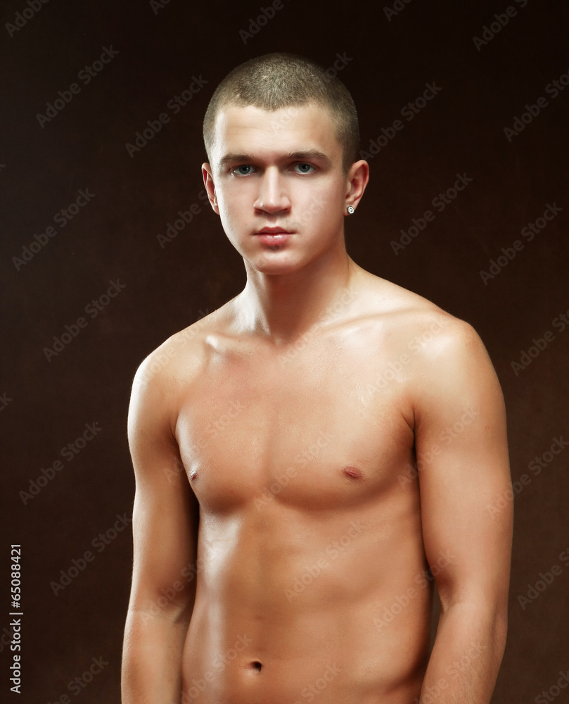 Portrait of a naked muscular man, isolated on black background Portrait of a naked muscular man, isolated on black background