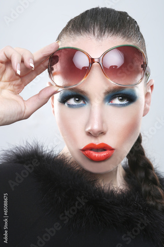 Stylish Woman With Beauty Makeup and Sunglasses
