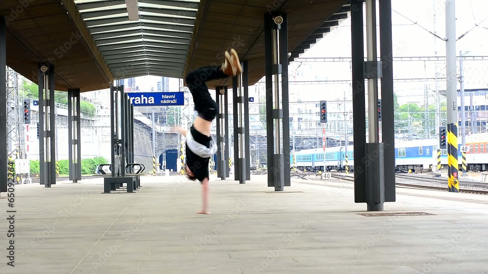 Breakdancer dancing breakdance at the train station in Prague Breakdancer dancing breakdance at the train station in Prague