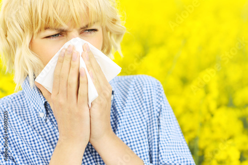 Woman with allergy over flowers