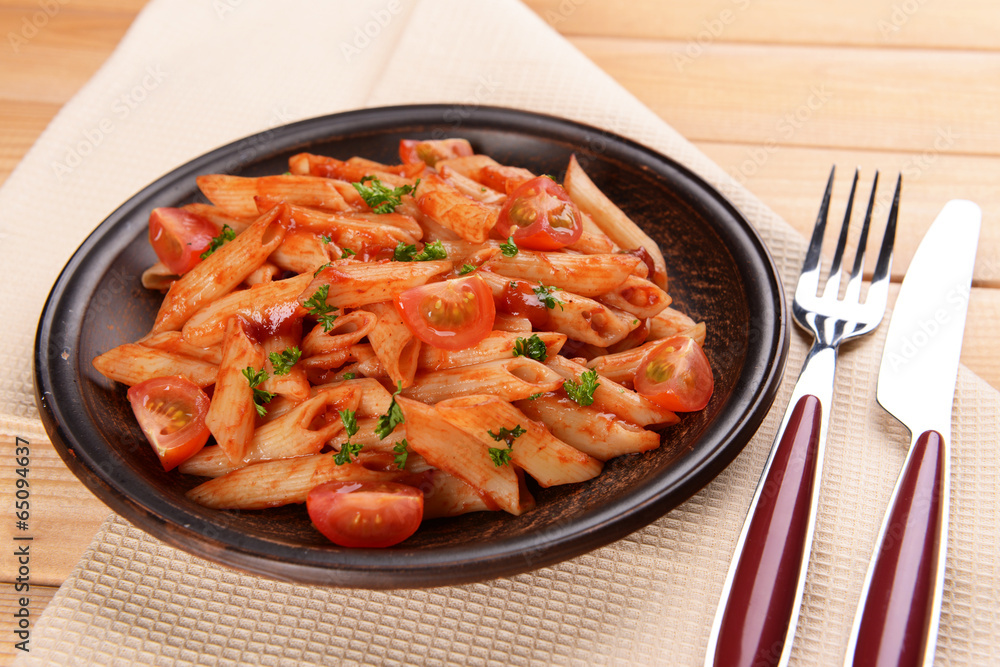 Pasta with tomato sauce on plate on table close-up Pasta with tomato sauce on plate on table close-up