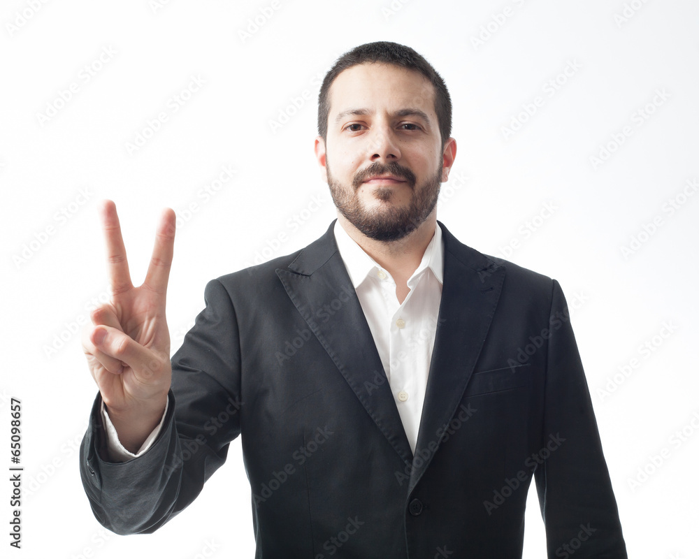 Young businessman showing peace sign. Isolated on white. Young businessman showing peace sign. Isolated on white.