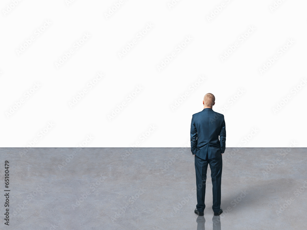 man looking at the white blank wall man looking at the white blank wall