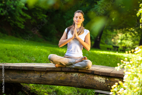 Young female meditate in nature